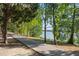 Scenic walking path alongside a lake with lush trees at 7315 River Hammock Dr # 206, Bradenton, FL 34212