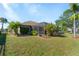 Large backyard with screened enclosure and lush landscaping at 7518 Paspalum, Punta Gorda, FL 33955