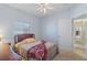 Bright bedroom with a view and ceiling fan at 7518 Paspalum, Punta Gorda, FL 33955