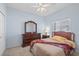 Cozy bedroom with wood furniture and a ceiling fan at 7518 Paspalum, Punta Gorda, FL 33955