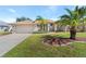 Tan house with a two-car garage and palm trees at 7518 Paspalum, Punta Gorda, FL 33955