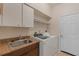 Laundry room with washer, dryer, and cabinets at 7518 Paspalum, Punta Gorda, FL 33955