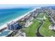 Elevated view showcasing golf course and beachfront condominiums, all within a meticulously planned coastal community at 775 Longboat Club Rd # 902, Longboat Key, FL 34228