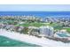 Breathtaking aerial view of a luxury beachfront condo, golf course, and stunning coastline, a golfer's paradise at 775 Longboat Club Rd # 902, Longboat Key, FL 34228
