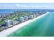 Expansive aerial view of luxury condos along the coastline, featuring pristine beaches and stunning turquoise water views at 775 Longboat Club Rd # 902, Longboat Key, FL 34228