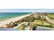 Stunning balcony view of the sandy beach, turquoise waters, and verdant landscape from the building at 775 Longboat Club Rd # 902, Longboat Key, FL 34228