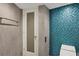 Spa-like bathroom featuring textured wall tiles, a walk-in shower, and a sleek toilet at 775 Longboat Club Rd # 902, Longboat Key, FL 34228
