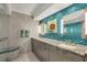 Elegant bathroom features double granite vanity, decorative mirrors, and decorative accent tiles at 775 Longboat Club Rd # 902, Longboat Key, FL 34228