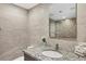 Stylish bathroom featuring modern fixtures, elegant tile work, and a well-lit vanity with countertop basin at 775 Longboat Club Rd # 902, Longboat Key, FL 34228