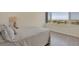 Bright bedroom with a large window offering panoramic views of the city and the ocean beyond at 775 Longboat Club Rd # 902, Longboat Key, FL 34228