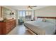 Relaxing bedroom with neutral tones, bright window view, and wooden dresser at 775 Longboat Club Rd # 902, Longboat Key, FL 34228