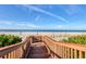 Charming boardwalk leading to a serene beach with turquoise water and soft sand at 775 Longboat Club Rd # 902, Longboat Key, FL 34228