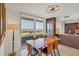 Light-filled dining room features wood table, modern lighting, and seamless access to the kitchen at 775 Longboat Club Rd # 902, Longboat Key, FL 34228