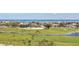 Picturesque golf course view featuring lush green fairways, palm trees, and a winding stream at 775 Longboat Club Rd # 902, Longboat Key, FL 34228