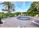 Inviting jacuzzi area with surrounding seating, lush landscaping and lounge chairs at 775 Longboat Club Rd # 902, Longboat Key, FL 34228
