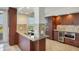 Modern kitchen with stainless steel appliances, granite countertops, custom cabinetry, and ocean view at 775 Longboat Club Rd # 902, Longboat Key, FL 34228