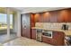 Well-equipped kitchen featuring stainless steel appliances, wine cooler, and ample cabinet space at 775 Longboat Club Rd # 902, Longboat Key, FL 34228