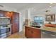 Modern kitchen featuring granite countertops, stainless steel appliances, and seamless access to the living area at 775 Longboat Club Rd # 902, Longboat Key, FL 34228