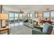 Bright living room featuring large windows with ocean view, comfortable seating and modern decor at 775 Longboat Club Rd # 902, Longboat Key, FL 34228