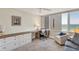 Home office featuring built-in desk and storage, neutral colors, and views of the ocean at 775 Longboat Club Rd # 902, Longboat Key, FL 34228
