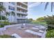 Relaxing outdoor pool area with lounge chairs, lush landscaping, and easy access to the beach at 775 Longboat Club Rd # 902, Longboat Key, FL 34228