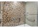 Close-up of the shower featuring intricate mosaic tile work, a built-in niche, and sleek fixtures at 775 Longboat Club Rd # 902, Longboat Key, FL 34228