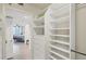 Spacious walk-in closet with custom shelving and drawers, providing ample storage space and easy organization solutions at 775 Longboat Club Rd # 902, Longboat Key, FL 34228