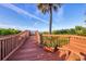 Wooden walkway with scenic views of beach and lush foliage at 775 Longboat Club Rd # 902, Longboat Key, FL 34228