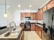 Kitchen with granite countertops, stainless steel sink, and ample cabinet space at 8267 Nandina Dr, Sarasota, FL 34240