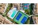 Aerial view showing tennis courts, pool, and surrounding buildings at 8335 Glenrose Way # 1513, Sarasota, FL 34238