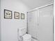 Simple bathroom with a shower, toilet and decorative art at 8335 Glenrose Way # 1513, Sarasota, FL 34238