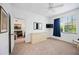 Bedroom with a dresser, view into living room, and plenty of natural light at 8335 Glenrose Way # 1513, Sarasota, FL 34238