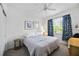 Bright bedroom with a king-size bed, ceiling fan, and large window at 8335 Glenrose Way # 1513, Sarasota, FL 34238