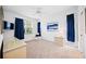 Well-lit bedroom featuring a TV, comfortable chair, and large windows at 8335 Glenrose Way # 1513, Sarasota, FL 34238