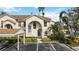 Condo building exterior with parking and lush landscaping at 8335 Glenrose Way # 1513, Sarasota, FL 34238