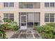 Ground level view of condo building exterior, showing a screened patio at 8335 Glenrose Way # 1513, Sarasota, FL 34238