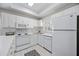 Clean and efficient kitchen with white cabinets and appliances at 8335 Glenrose Way # 1513, Sarasota, FL 34238