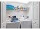 Laundry closet with washer, dryer, and shelving at 8335 Glenrose Way # 1513, Sarasota, FL 34238