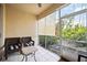 Relaxing screened patio with wicker chairs and view of lush landscaping at 8335 Glenrose Way # 1513, Sarasota, FL 34238