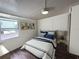 Stylishly decorated bedroom featuring a cozy bed, modern decor, and a bright window at 2601 Gulf N Dr # 613, Bradenton Beach, FL 34217