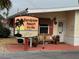 Sandpiper Resort Co-Op sign with a view of the office and benches at 2601 Gulf N Dr # 613, Bradenton Beach, FL 34217