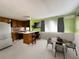Open floor plan with wood floors, breakfast bar, and dining table is great for entertaining at 2601 Gulf N Dr # 613, Bradenton Beach, FL 34217