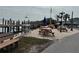 Picturesque waterfront deck featuring picnic tables, a grill, and a relaxing bench for enjoying the view at 2601 Gulf N Dr # 613, Bradenton Beach, FL 34217