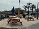 Community waterfront seating with tables, umbrellas, and lounge chairs at 2601 Gulf N Dr # 613, Bradenton Beach, FL 34217