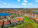 A charming home with a tile roof and a screened-in pool is nestled in a vibrant community near a beautiful lake at 10120 Carnoustie Pl, Bradenton, FL 34211