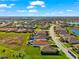 This aerial shot showcases a beautiful home in a serene neighborhood, with a tranquil lake and lush green landscape at 10120 Carnoustie Pl, Bradenton, FL 34211