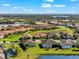 Lush suburban community with tile roofed homes, ponds and green lawns seen from above on a clear day at 10120 Carnoustie Pl, Bradenton, FL 34211