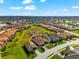 Expansive aerial view of a beautiful single-Gathering home with a tile roof in a well-maintained community at 10120 Carnoustie Pl, Bradenton, FL 34211