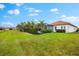 The house with lush landscaping and a screened-in lanai overlooking the beautifully manicured backyard at 10120 Carnoustie Pl, Bradenton, FL 34211