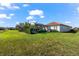 Lush backyard with manicured hedge, screened lanai, and well-kept lawn, creating a private outdoor space at 10120 Carnoustie Pl, Bradenton, FL 34211